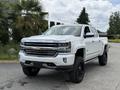 A white 2017 Chevrolet Silverado 1500 pickup truck with black wheels featuring a chrome front grille and prominent Chevrolet logo