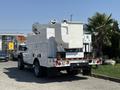 A white 2008 Ford F-550 bucket truck with an elevated work platform and various compartments for tools and equipment