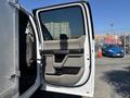 The image shows the open door of a 2019 Ford F-550 revealing a beige and black interior design with a handle and control panel visible