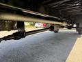 Undercarriage view of a 2009 International 3000 CE showing the rear axle suspension system and transmission components