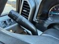 A steering column lever from a 2020 Ford F-350 featuring controls for headlights and windshield wipers