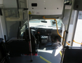 Interior view of a 2020 Chevrolet Express showing the driver's seat dashboard and controls with a step area leading outside