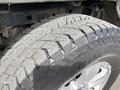 Close-up of a worn tire on a 2015 Ford F-150 showing tread patterns with visible dirt and wear