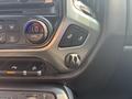 Interior controls of a 2017 Chevrolet Silverado 1500 featuring heating buttons and a climate control dial