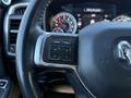 The steering wheel of a 2021 RAM 3500 with control buttons including phone and voice activation options