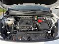Engine compartment of a 2020 Ford Escape with visible engine components battery and coolant reservoir