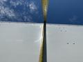 Close-up of a 2012 Ford Econoline with a measuring tape extended along the edge of the vehicle's exterior surface