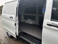 A 2021 Mercedes-Benz Metris with an open side door showing the spacious cargo area and black flooring