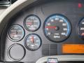 Dashboard of a 2008 International 4300 with gauges for RPM, oil pressure, water temperature, transmission temperature and warning lights displayed