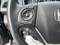 Steering wheel of a 2014 Honda CR-V with control buttons for volume source and menu