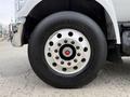 Close-up of the wheel of a 2019 Ford F-750 showing a shiny chrome hubcap with a red center and a large black tire labeled Continental