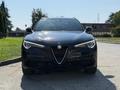 A 2020 Alfa Romeo Stelvio facing forward with distinctive headlights and a prominent grille featuring the Alfa Romeo emblem