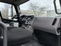 Interior view of a 2005 Freightliner M2 106 showing the driver's seat dashboard and controls