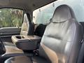 A black leather interior of a 2009 Ford F-550 featuring two front seats with a center console between them