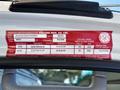 A 2022 Isuzu NRR truck registration label with vehicle specifications including VIN, gross weight, tire sizes, and ownership information