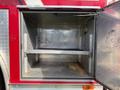 An open compartment of a 1992 Emergency One Typhoon Superior fire truck showing a metal interior with a shelf and no items inside