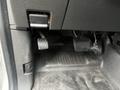 The interior footwell of a 2013 Ford F-150 showing the brake and accelerator pedals with a rubber mat on the floor