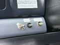 Interior dashboard of a 2001 Ford F-350 featuring two toggle switches labeled Beacon and Wig Wags