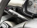 Close-up of a 2009 UD Trucks UD 3300 steering column with various control stalks and dials visible on the dashboard