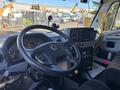 Interior view of a 2022 Lion Lion6 with a steering wheel instrument panel and display screen visible