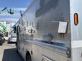 A silver 2008 Workhorse W62 vehicle with a smooth metallic surface and various attachments on the side