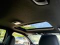 The interior of a 2024 Kia Forte5 featuring a panoramic sunroof and dark fabric upholstery on the ceiling and seats