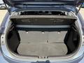 The trunk space of a 2018 Kia Rio5 with a folded rear seat showing a spacious area for storage