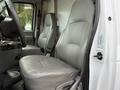 View of the interior of a 2007 Ford E-350 showing two gray leather front seats and part of the dashboard