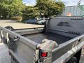 A 2013 RAM 5500 truck bed with a flat black surface and visible hooks for securing cargo