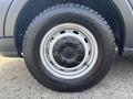 A close-up view of the wheel and tire of a 2016 Ford Transit 150 featuring a silver rim and a robust black tire with visible tread patterns