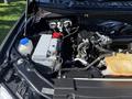 The image shows the engine compartment of a 2018 Ford F-150 with visible engine components including the battery and various hoses and connectors.