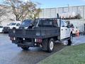 A 2020 Ford F-350 with a flatbed truck design featuring a black mesh side and rear rail and dual rear wheels