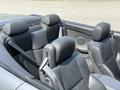 Interior view of a 2004 BMW 6-Series convertible with leather seats and seatbelts visible in the foreground