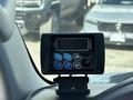 A digital display unit mounted on a dashboard with buttons for settings and programming