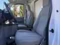 Interior view of a 2019 Ford E-450 showing two gray bucket seats and a center console
