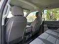 Interior view of a 2024 Ford F-550 showing two front seats with gray upholstery and a center console