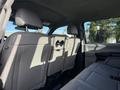 The interior of a 2020 Ford F-550 showing the back seat with light gray upholstery and headrests visible