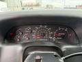 Dashboard of a 2004 Ford F-750 featuring speedometer fuel gauge and various indicator lights