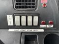 Control panel with various buttons and switches labeled with functions such as UP DOWN CONT STAB BODY AJAR and TAILGATE AJAR
