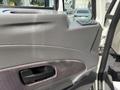 Interior door panel of a 2013 International WorkStar featuring a door handle and control buttons
