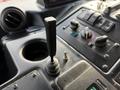The interior dashboard of a 2010 Autocar Xpeditor featuring a gear shift lever and various controls and switches