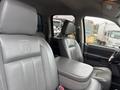 Interior of a 2006 Dodge Ram 2500 featuring leather seats with the Dodge Ram logo on the headrest and a central armrest between the front seats