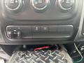 A close-up view of the dashboard controls in a 2016 RAM 1500 featuring buttons for adjusting settings and a tow/haul mode indicator