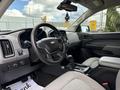 Interior of a 2018 Chevrolet Colorado featuring a steering wheel dashboard and center console with controls and a gear shifter