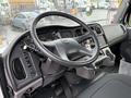 Interior view of a 2005 Freightliner M2 106 truck featuring a steering wheel dashboard and various control levers and gauges