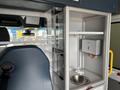 Interior view of a 2020 Mercedes-Benz Sprinter 2500 showing a compact kitchen area with a sink and storage compartments