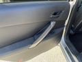 A 2006 Pontiac G6 car door with a black interior panel and a silver handle