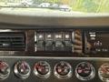 Dashboard controls of a 2018 Kenworth T800 featuring switches for lights and other functions with gauges displaying fuel and engine information