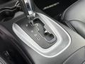 Close-up of the gear shift of a 2013 Dodge Journey showing the shift pattern with letters P R N D and a silver handle
