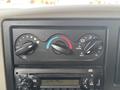 The dashboard controls of a 2013 International WorkStar including knobs for fan speed temperature and vent settings along with a radio display